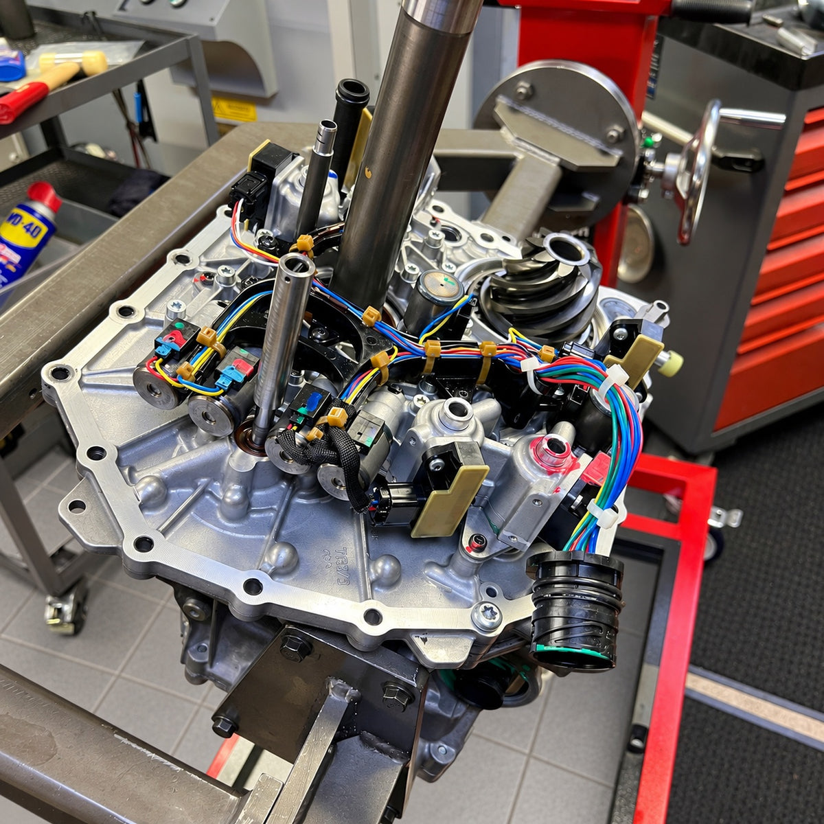 Getrag 7DCL750 transmission assembly with shafts, sensors and wiring during GTE Engineering workshop rebuilding