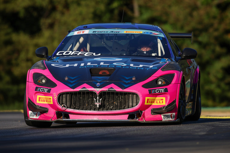 GTE Engineering and black race car on a track with blurred background