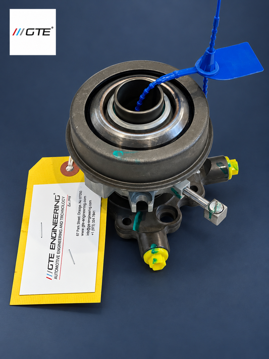 Rebuilt hydraulic clutch release bearing showing bearing face, capped ports and inspection tag