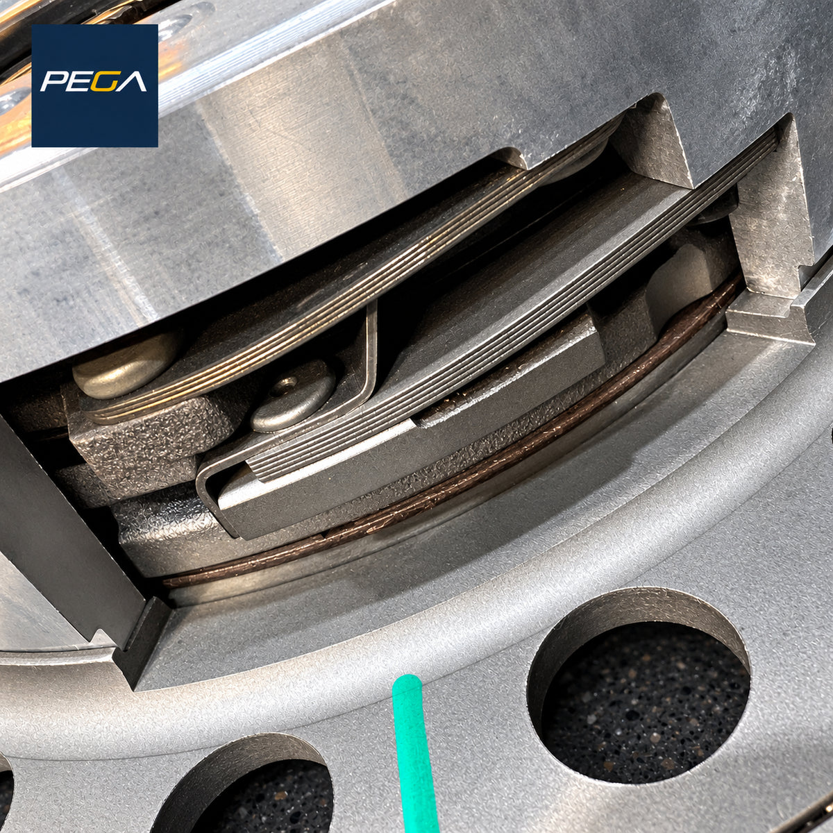 Aston Martin clutch service example showing spring straps, stacked friction plates and a green witness mark