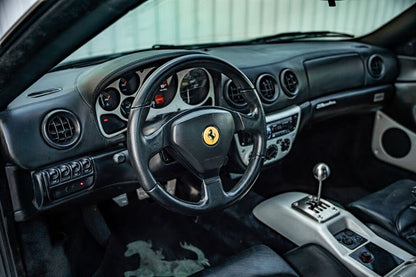 Ferrari 360 interior with a gated manual lever, black seats and dashboard; installation example.