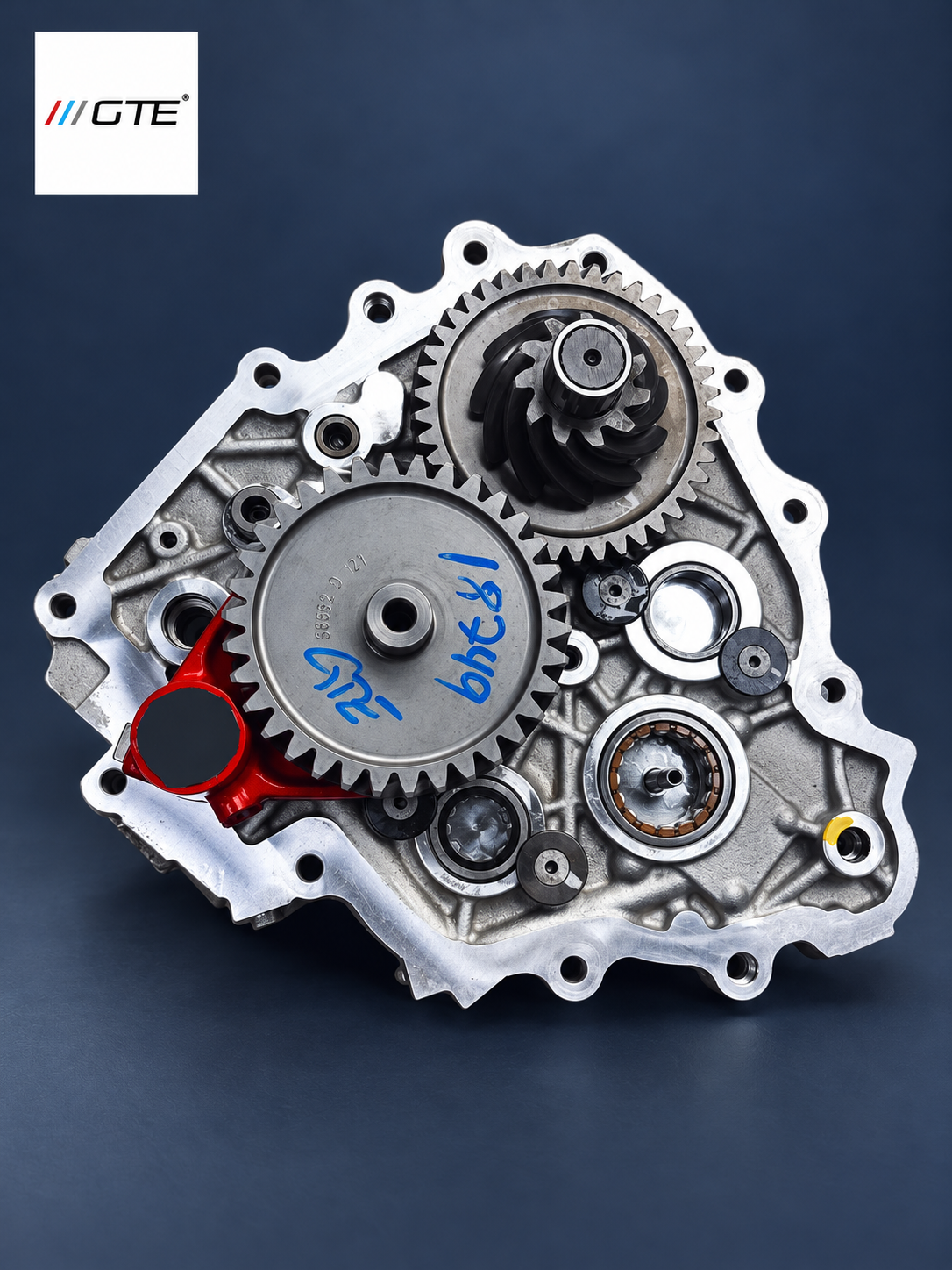 Ferrari PTU service example with an open gearcase, exposed gears, red selector fork and blue witness marks in GTE studio presentation.