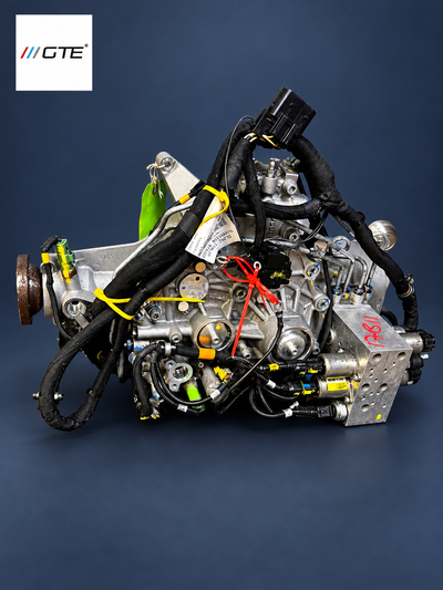 Angled front view of a Ferrari FF and GTC4Lusso 4RM PTU showing the hydraulic block, solenoids, metal pipes and wiring harness.