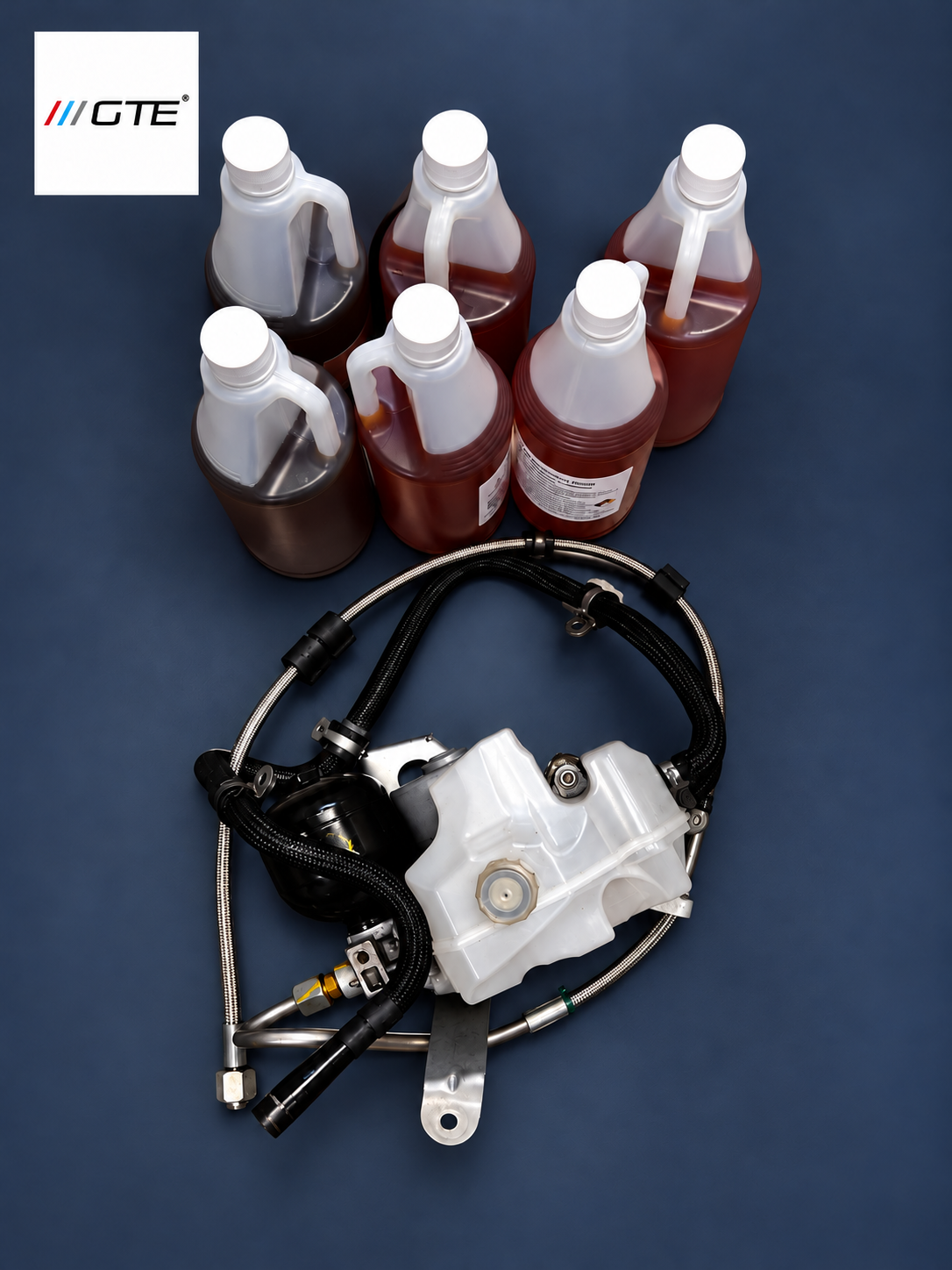 Ferrari FF and GTC4Lusso PTU power unit with high-pressure and return hoses, shown with PTU oil bottles.