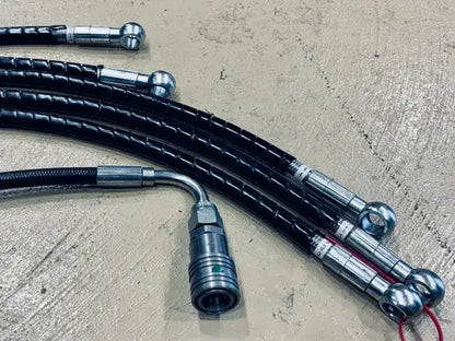 Shared Ferrari hydraulic-hose workmanship example showing banjo ends, crimp sleeves and a quick-coupler; not a part-specific kit or included quantity