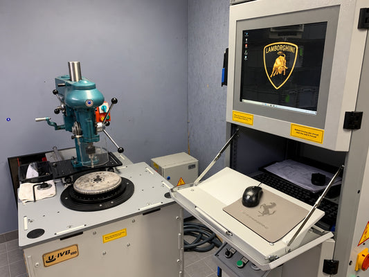GTE workshop balancing machine beside its control monitor, with a round component on the machine table
