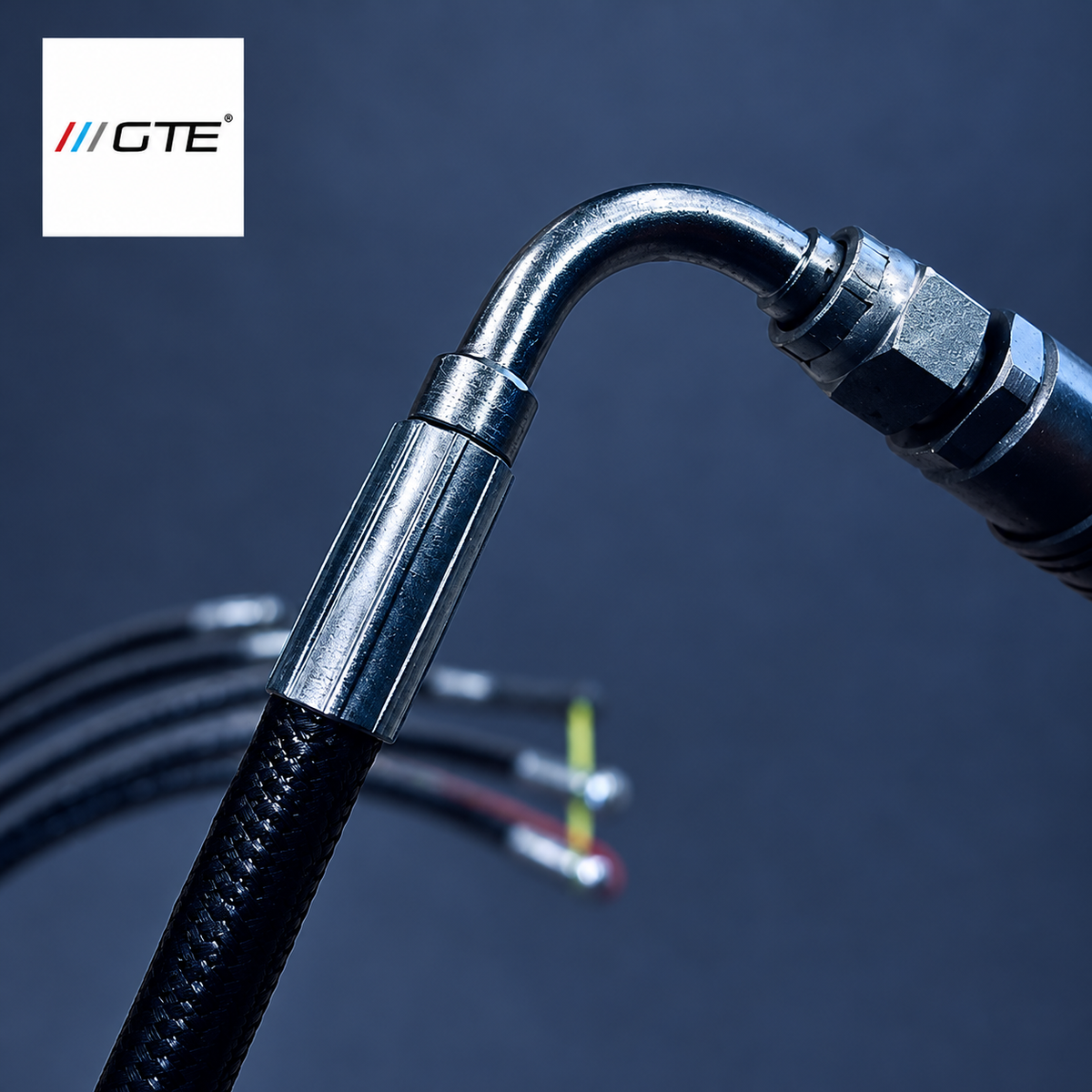 GTE hydraulic-hose workmanship example showing a curved elbow, hex fitting and crimp sleeve on black braided hose; shared detail view, not a specific six-hose set