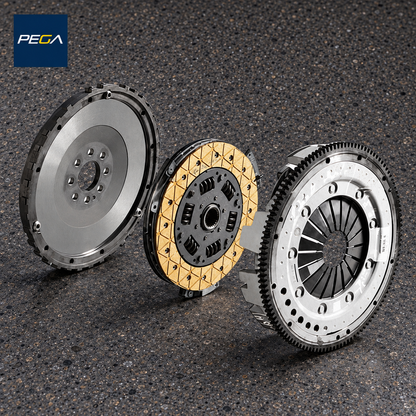 Lamborghini Gallardo E-Gear service example showing a flywheel, yellow-lined sprung clutch disc and pressure plate; exact assembly version is not identified by this photo
