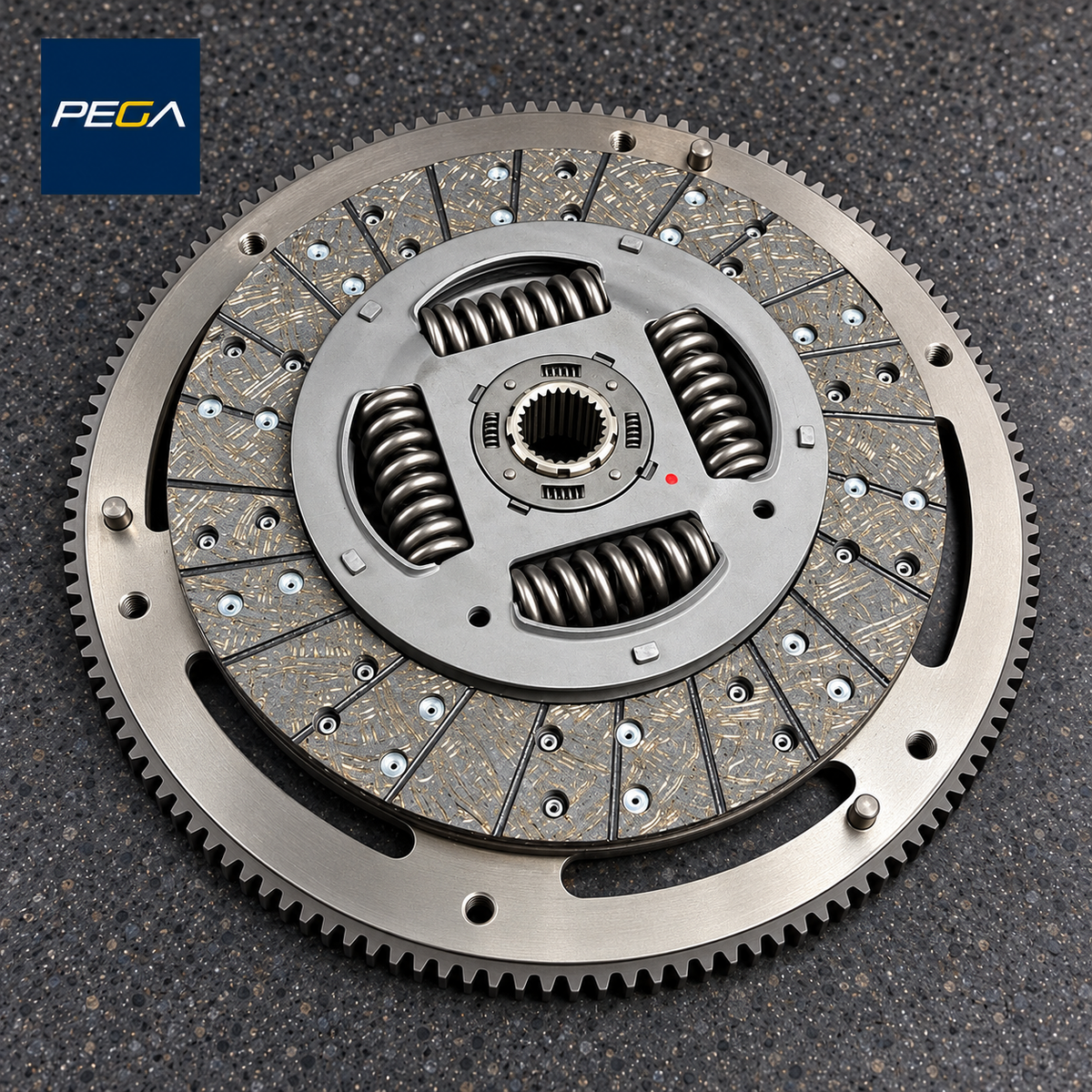 PEGA Stage 1 Organic clutch friction disc example resting on a flywheel; flywheel service is separate